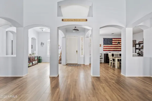 a view of a hallway with wooden floor windows and livingroom