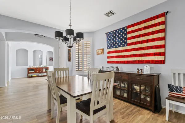 a dining room with furniture and wooden floor