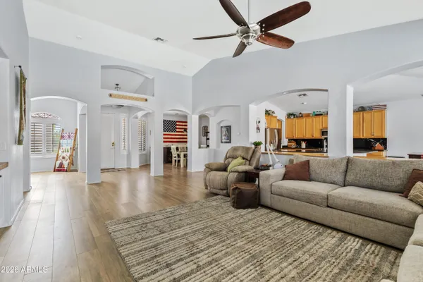 a living room with furniture and a wooden floor
