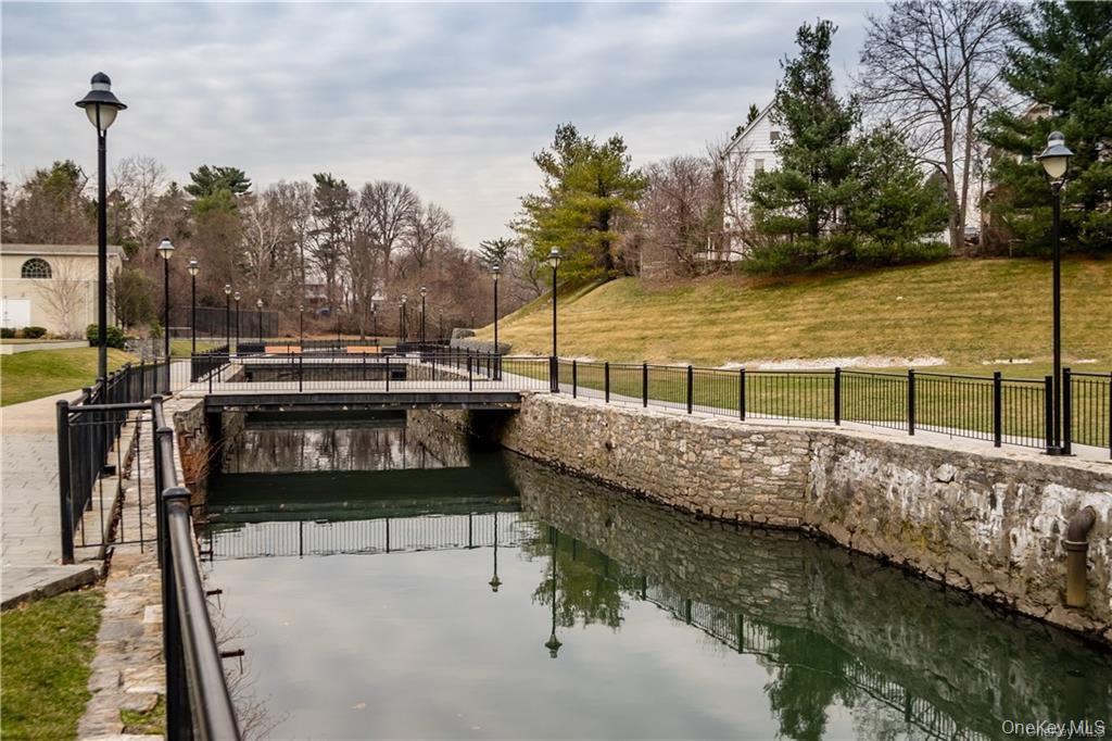 111 Kensington Road, Unit 8 Bronxville, NY 10708 - Photo 14 of 16 a view of a lake with chairs