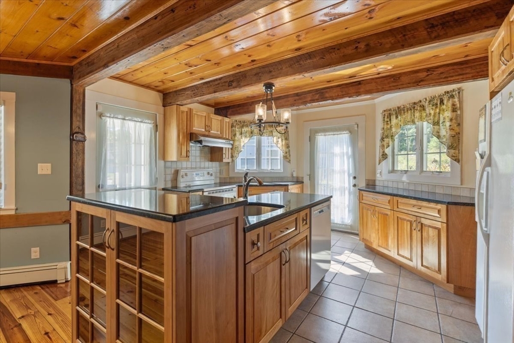 16 Indian Lane Canton, MA 02021 - Photo 11 of 36 a kitchen with stainless steel appliances granite countertop a sink and cabinets