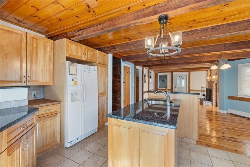 16 Indian Lane Canton, MA 02021 - Photo 14 of 36 a dining table with chairs and chandelier