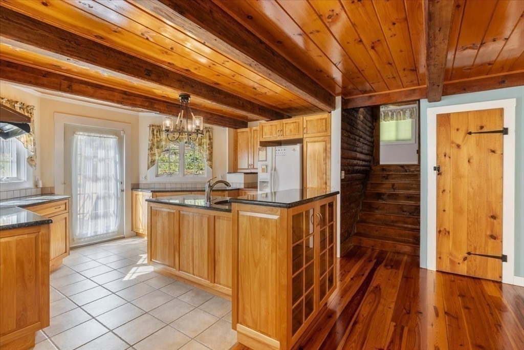 16 Indian Lane Canton, MA 02021 - Photo 15 of 36 a view of a kitchen with wooden floor and furniture