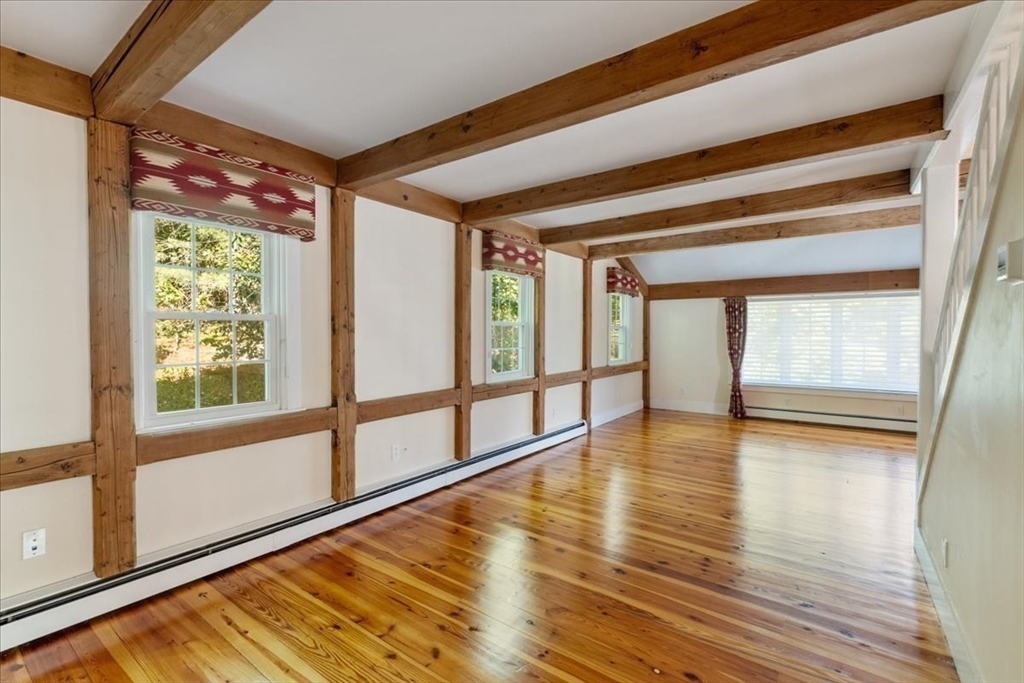 16 Indian Lane Canton, MA 02021 - Photo 16 of 36 a view of an empty room with wooden floor and a window