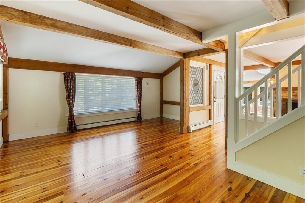 16 Indian Lane Canton, MA 02021 - Photo 19 of 36 a view of an empty room with wooden floor and windows