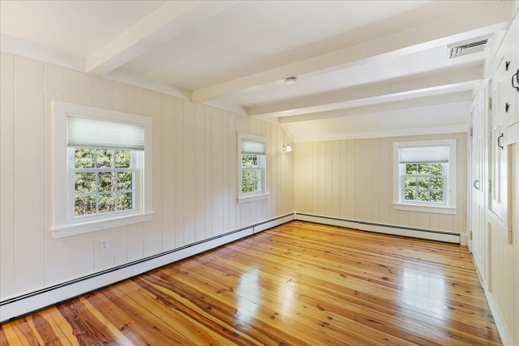 16 Indian Lane Canton, MA 02021 - Photo 20 of 36 an empty room with wooden floor and windows