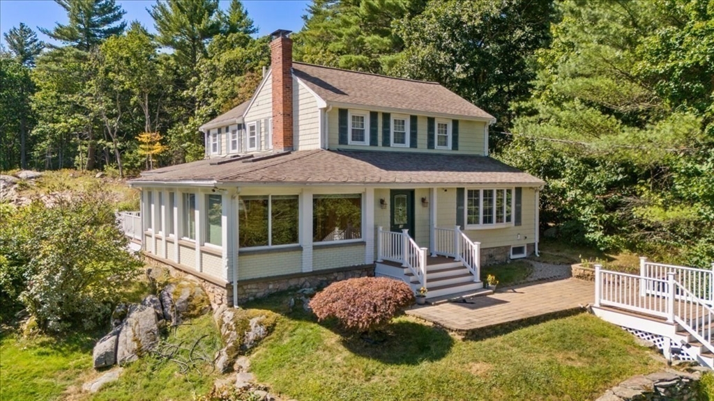 16 Indian Lane Canton, MA 02021 - Photo 2 of 36 a front view of a house with a yard table and chairs