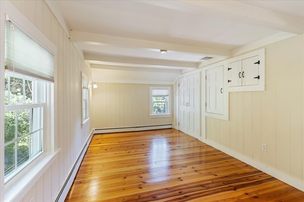 16 Indian Lane Canton, MA 02021 - Photo 21 of 36 a view of an empty room with wooden floor and a window