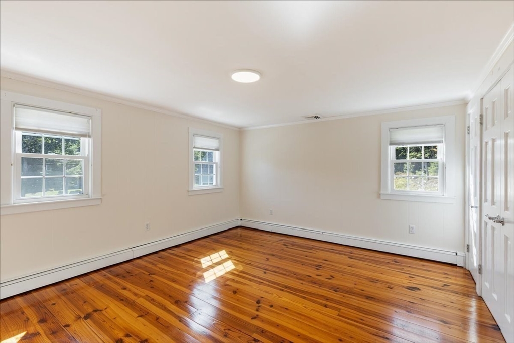 16 Indian Lane Canton, MA 02021 - Photo 28 of 36 a view of empty room with wooden floor and fan