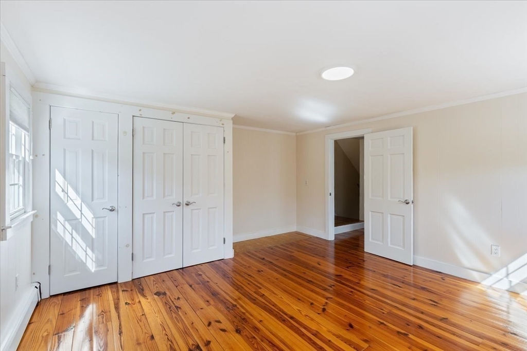 16 Indian Lane Canton, MA 02021 - Photo 29 of 36 a view of an empty room with wooden floor