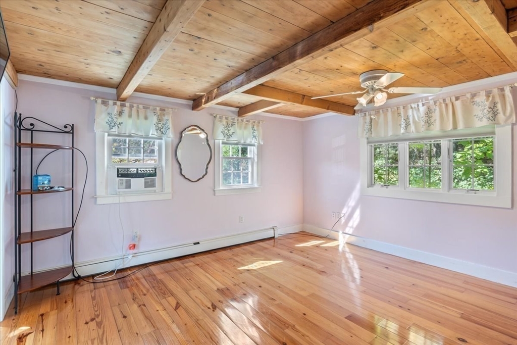 16 Indian Lane Canton, MA 02021 - Photo 30 of 36 a view of empty room with wooden floor and fan