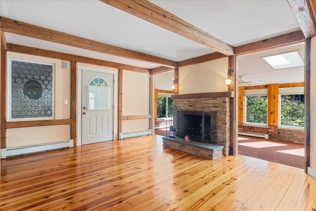 16 Indian Lane Canton, MA 02021 - Photo 6 of 36 a view of an empty room with wooden floor fireplace and a window