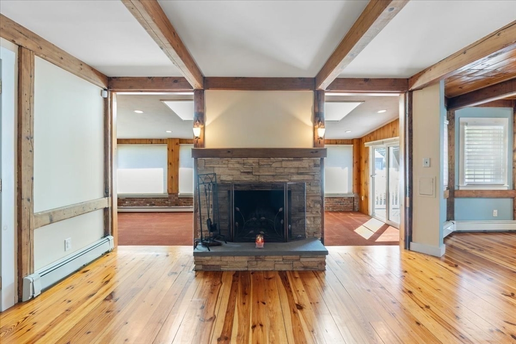16 Indian Lane Canton, MA 02021 - Photo 7 of 36 a view of a livingroom with wooden floor and a fireplace