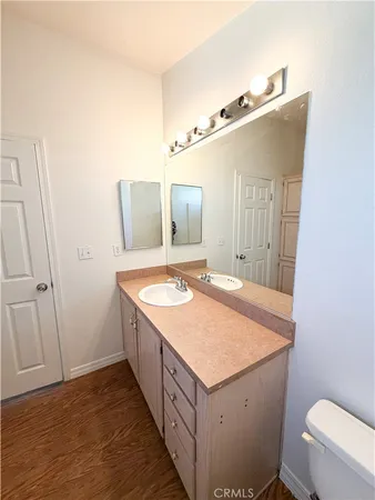 a bathroom with a sink a toilet and mirror