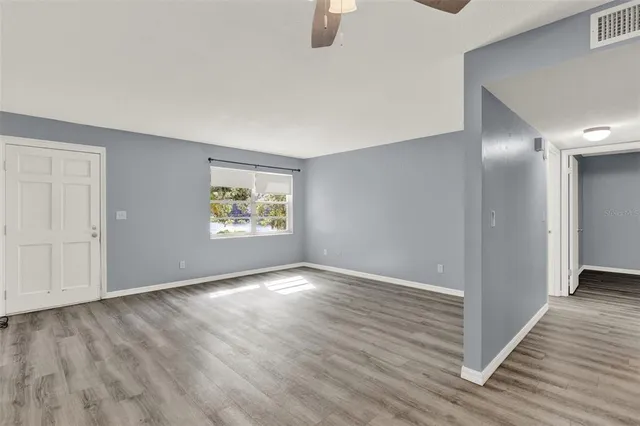 wooden floor in an empty room with a window