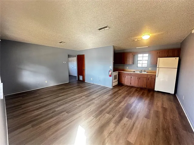a view of a kitchen with a sink and a stove top oven