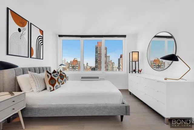 a bedroom with a large bed and a large window