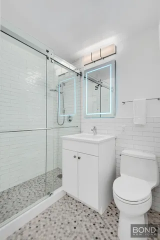a bathroom with a sink toilet and shower