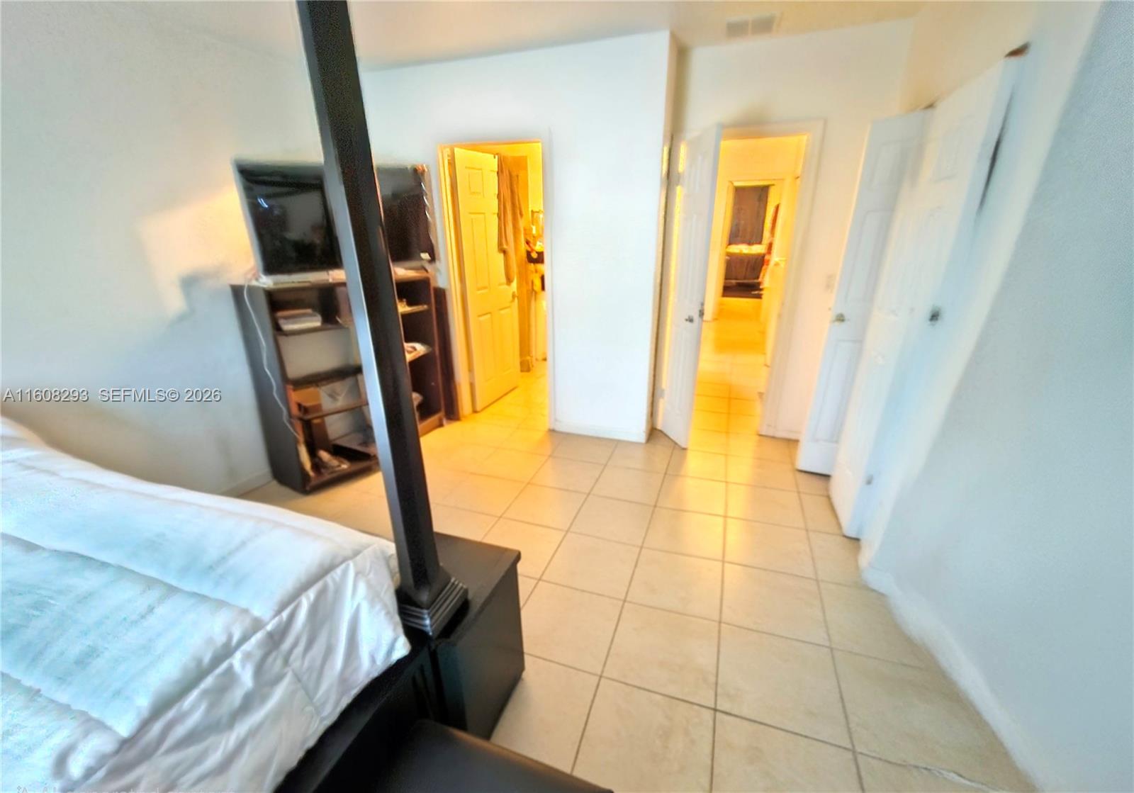 3556 Oleander Terrace, Unit 3556 Riviera Beach, FL 33404 - Photo 11 of 36 a bedroom with a bed and a mirror