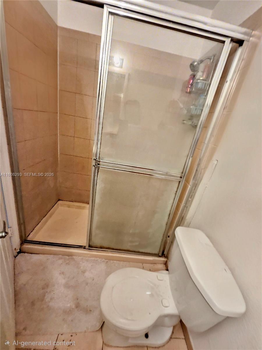 3556 Oleander Terrace, Unit 3556 Riviera Beach, FL 33404 - Photo 13 of 36 a bathroom with a shower and toilet