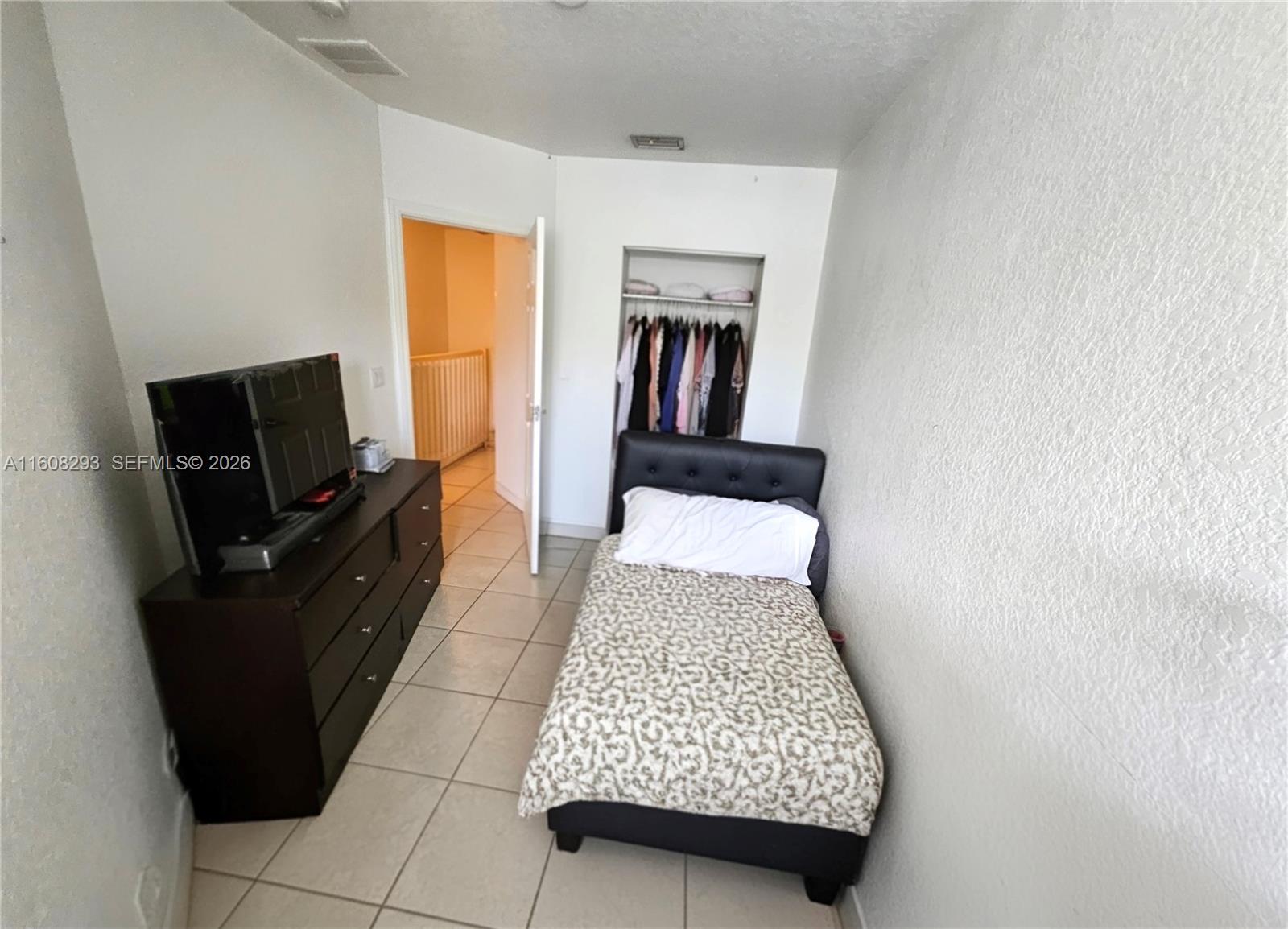 3556 Oleander Terrace, Unit 3556 Riviera Beach, FL 33404 - Photo 14 of 36 a living room with furniture and a flat screen tv