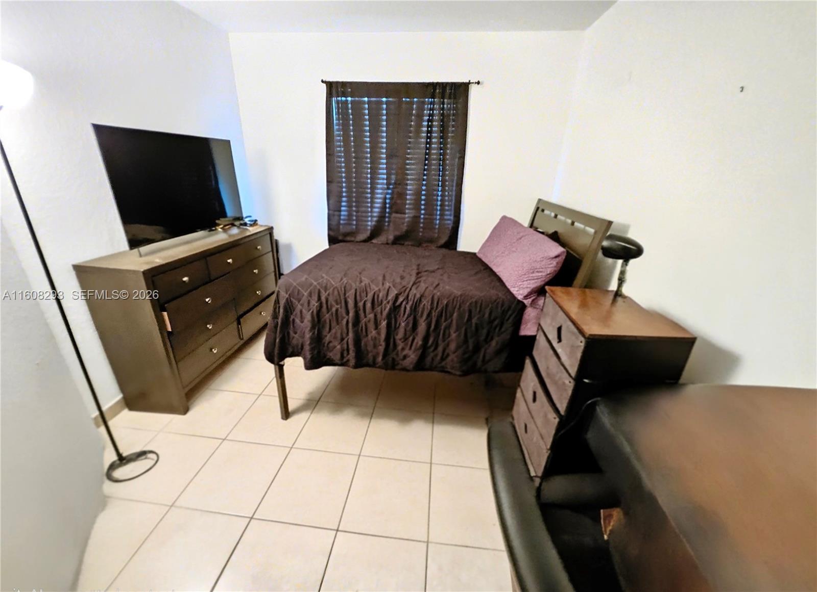 3556 Oleander Terrace, Unit 3556 Riviera Beach, FL 33404 - Photo 15 of 36 a bedroom with a bed and flat tv screen on the dresser