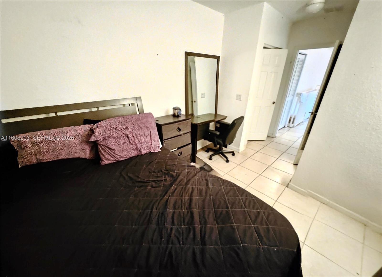 3556 Oleander Terrace, Unit 3556 Riviera Beach, FL 33404 - Photo 16 of 36 a bedroom with a bed and a potted plant on the table