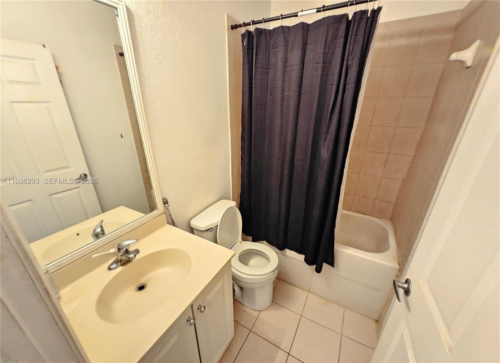 3556 Oleander Terrace, Unit 3556 Riviera Beach, FL 33404 - Photo 17 of 36 a bathroom with a sink and mirror with toilet