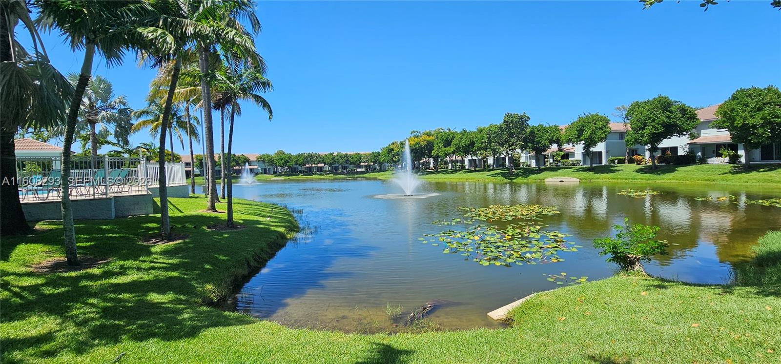 3556 Oleander Terrace, Unit 3556 Riviera Beach, FL 33404 - Photo 23 of 36 a view of a lake with a building in the background