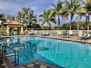 3556 Oleander Terrace, Unit 3556 Riviera Beach, FL 33404 - Photo 35 of 36 a view of swimming pool with a table and chairs