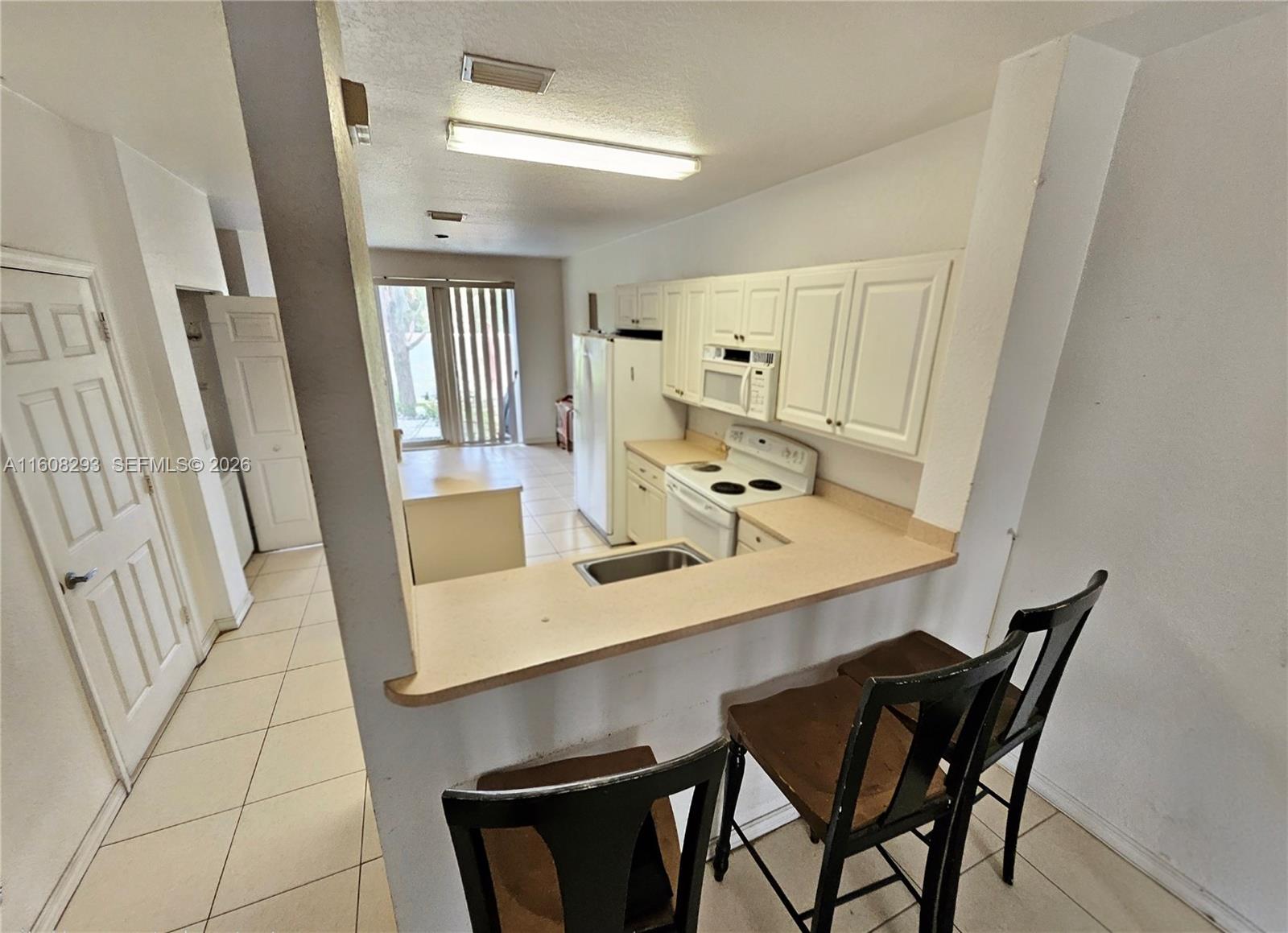 3556 Oleander Terrace, Unit 3556 Riviera Beach, FL 33404 - Photo 4 of 36 a view of a dining room with furniture and wooden floor