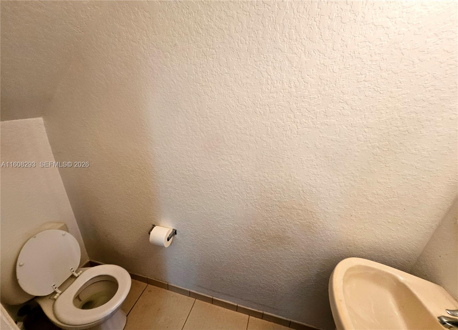 3556 Oleander Terrace, Unit 3556 Riviera Beach, FL 33404 - Photo 8 of 36 a bathroom with a toilet and a sink