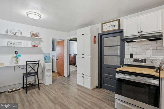 a kitchen with stainless steel appliances a stove a refrigerator and cabinets