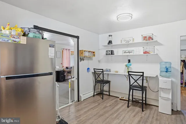 a kitchen with stainless steel appliances a refrigerator and a stove top oven