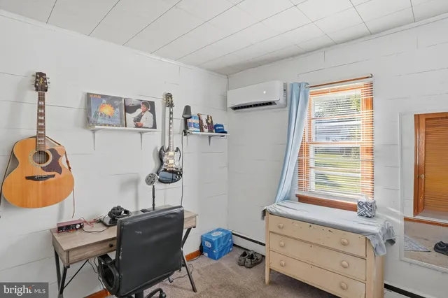 a bedroom with a window and a dresser