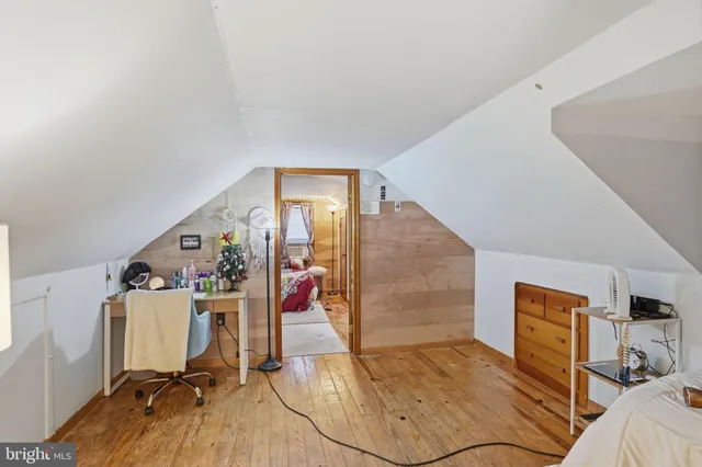 a view of a bedroom with a bed and workspace