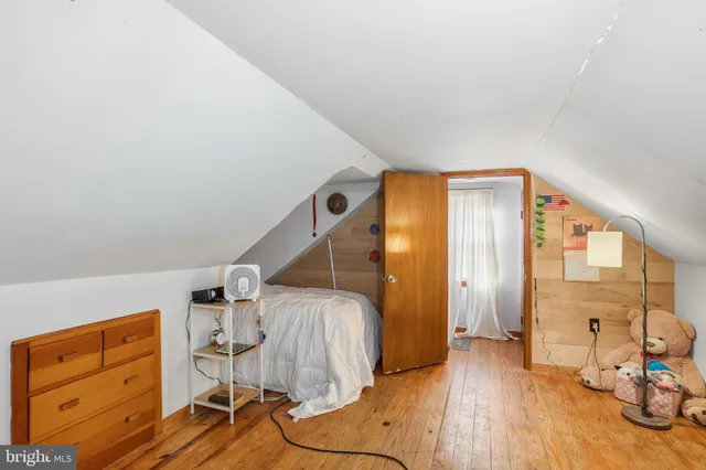 a view of a livingroom with wooden floor and white walls