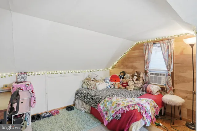 a bed room with a bed and a chair