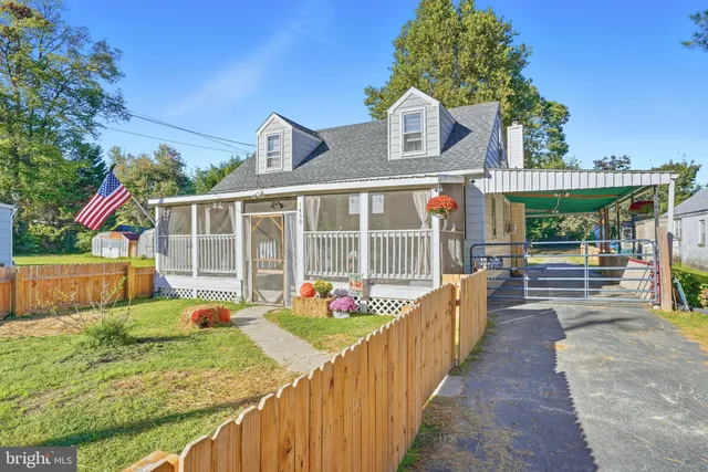 a view of a house with wooden fence