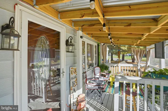 a view of a chair and tables in balcony front of house