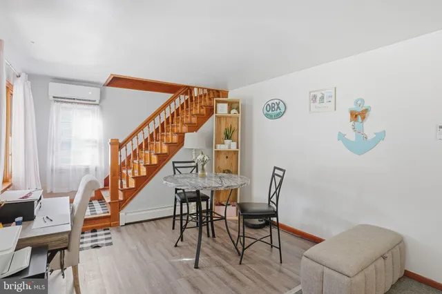 a view of entryway with furniture and wooden floor