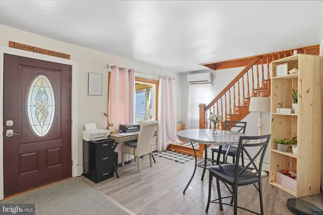 a view of a a dining room with furniture window and wooden floor