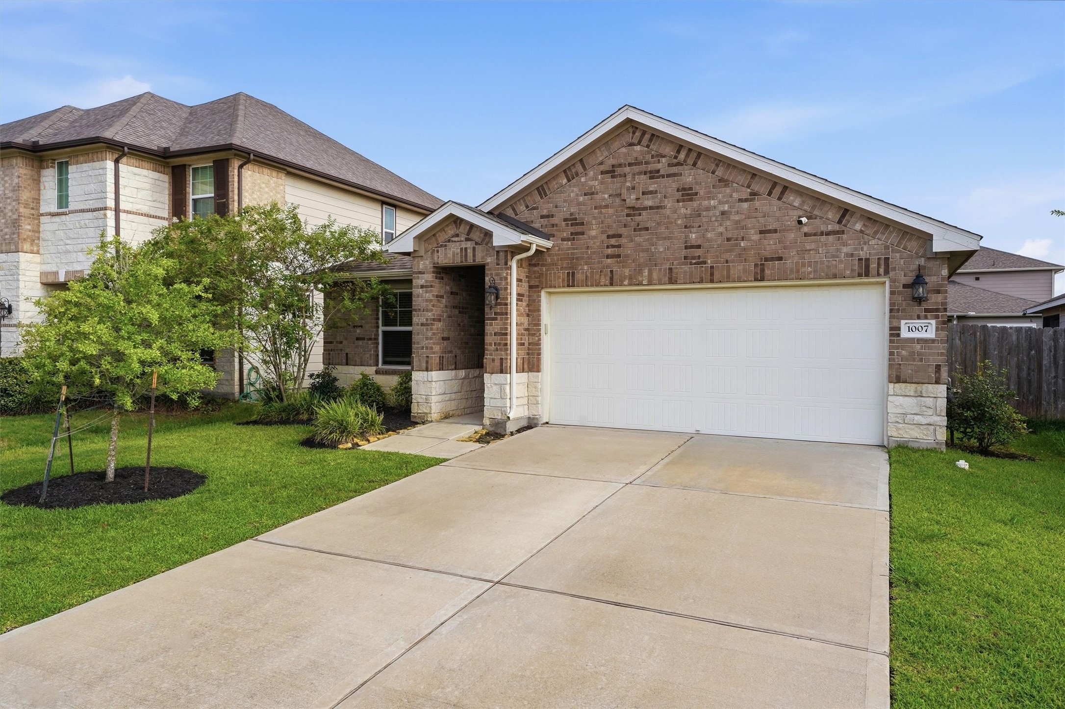 1007 Modesto Drive Rosharon, TX 77583 - Photo 2 of 25 Another look at the inviting exterior and spacious driveway leading to the covered front entry.