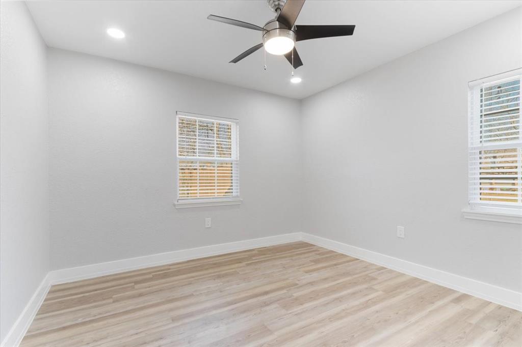 112 North Masters Drive Dallas, TX 75217 - Photo 12 of 22 an empty room with a window and a ceiling fan