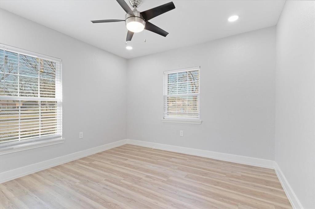112 North Masters Drive Dallas, TX 75217 - Photo 15 of 22 wooden floor in an empty room with a window