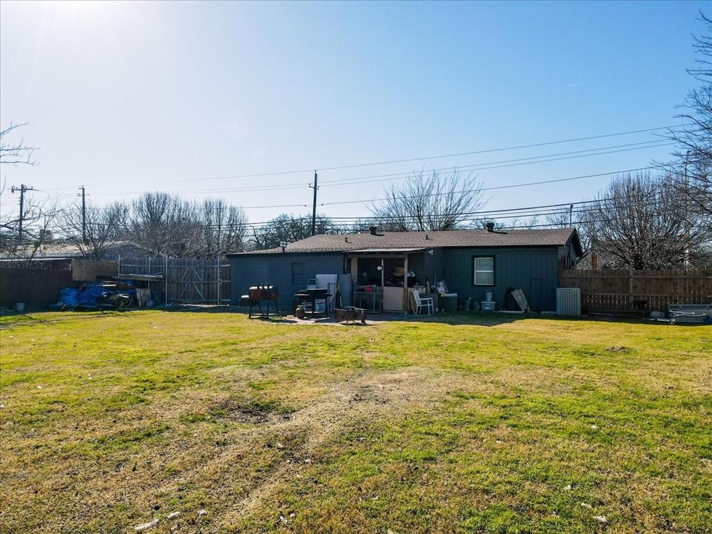 112 North Masters Drive Dallas, TX 75217 - Photo 21 of 22 a view of a house with a yard and a large tree