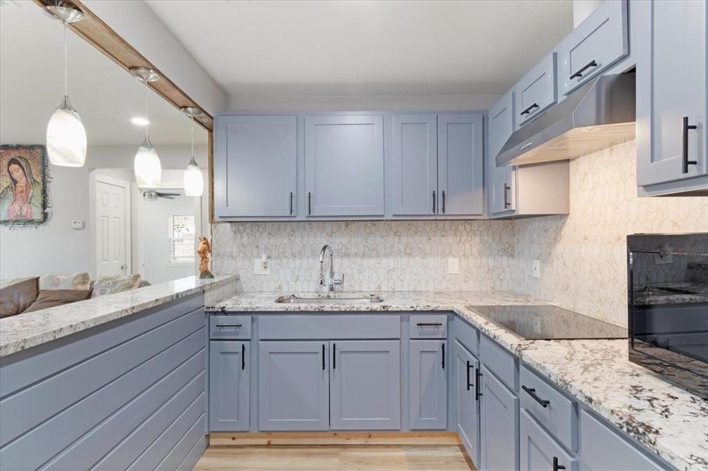 112 North Masters Drive Dallas, TX 75217 - Photo 6 of 22 a kitchen with a sink and cabinets