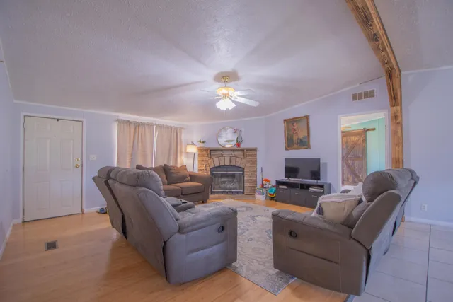 a living room with furniture fireplace and a window