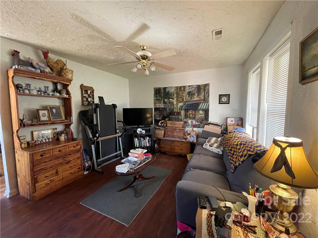 7400 R R H Road Hickory, NC 28602 - Photo 5 of 30 a living room with furniture gym equipment and a flat screen tv