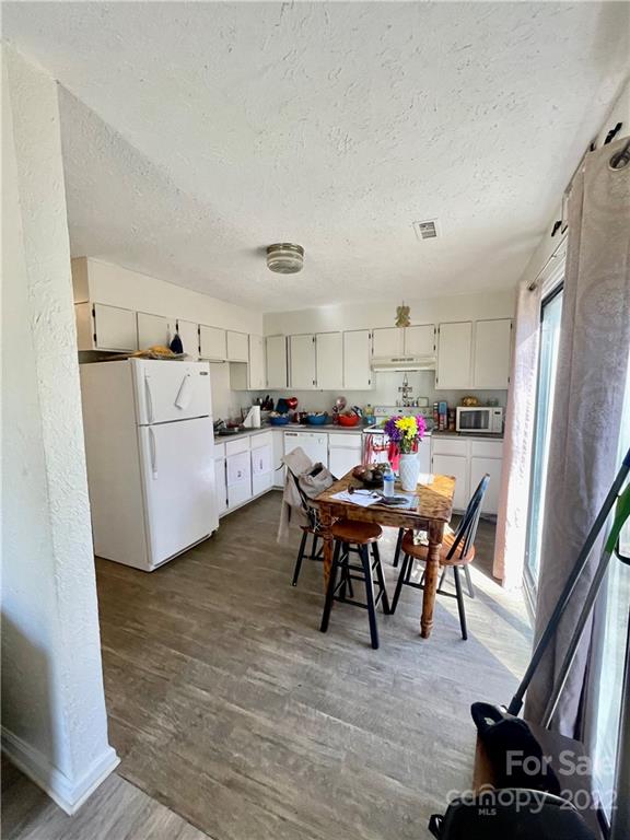 7400 R R H Road Hickory, NC 28602 - Photo 8 of 30 a living room with furniture and a dining table with kitchen view